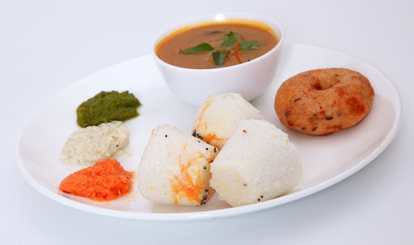 Idli and vada served with sambar and coconut chutney